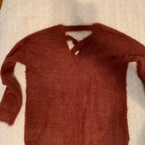 Orange/copper colored fuzzy sweater.